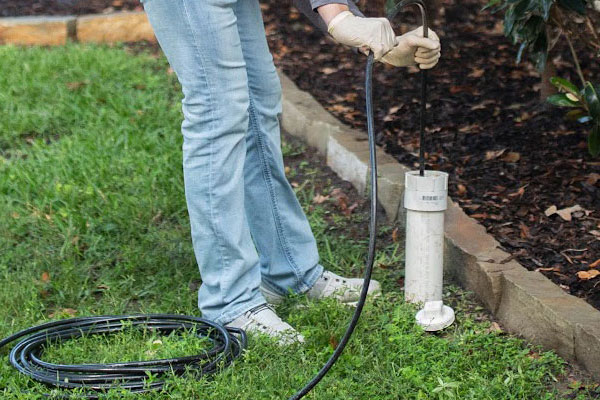 A plumber feeding a cable into a pipe